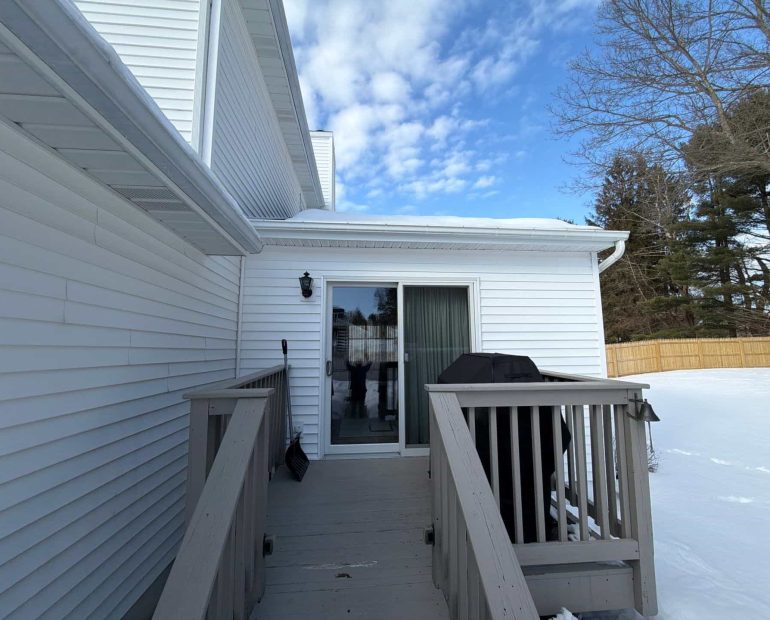 Emergency roof inspection showing snow buildup near roof edge and gutter after winter storm