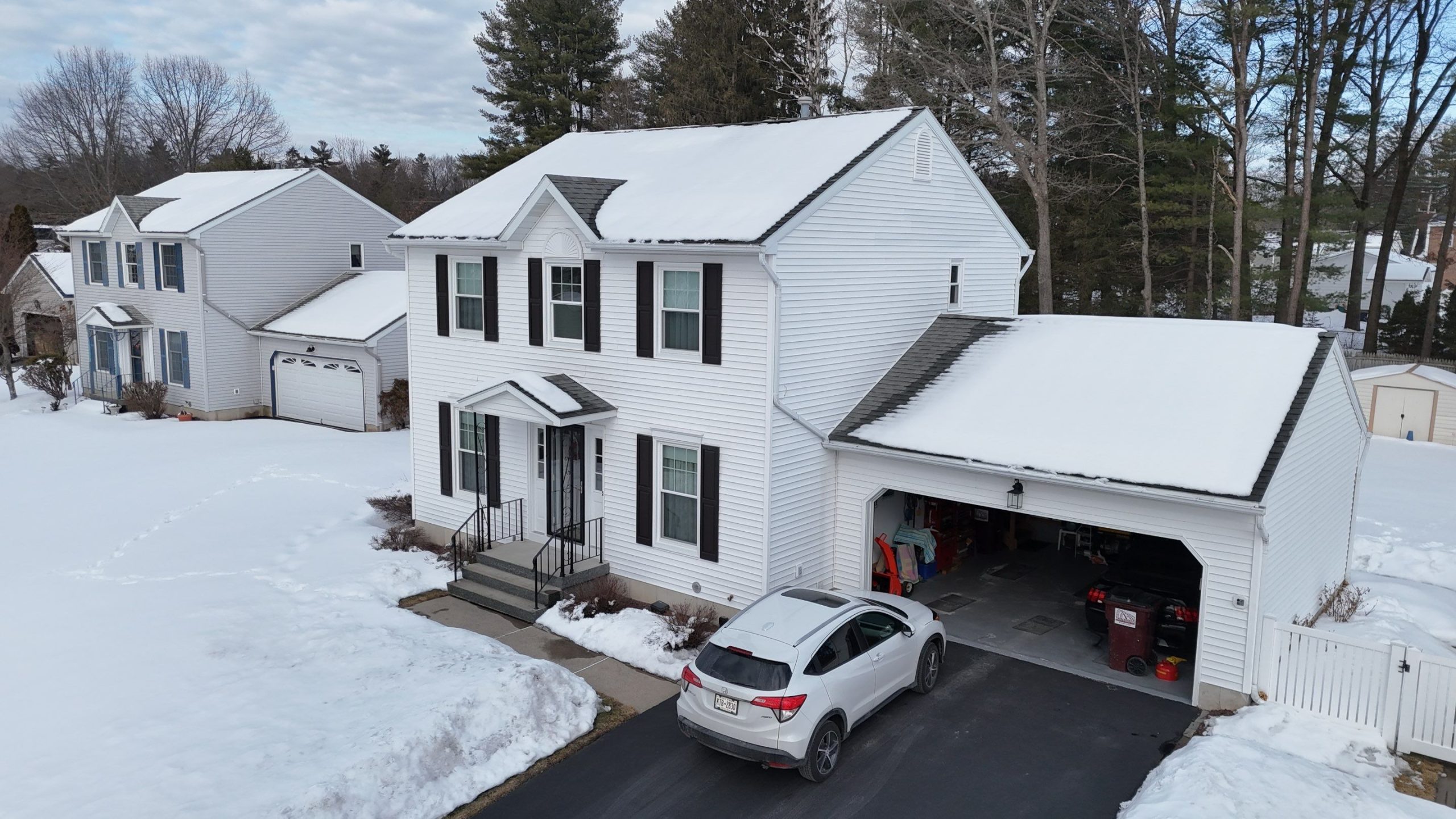Residential house roof covered with snow showing roofing material performance in cold climate conditions