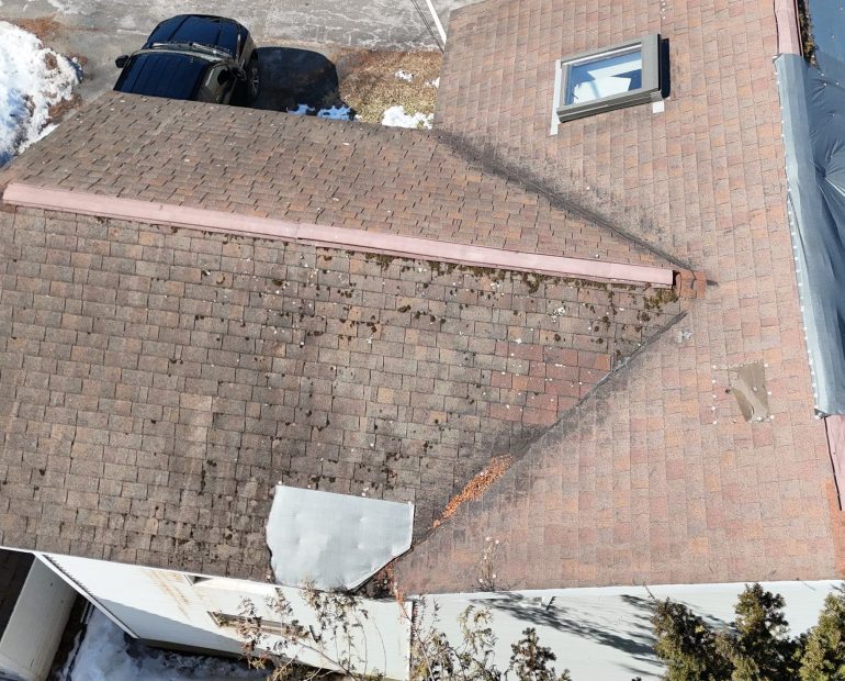 Damaged asphalt shingle roof with poor ventilation and moisture buildup affecting roof lifespan and increasing home energy bills