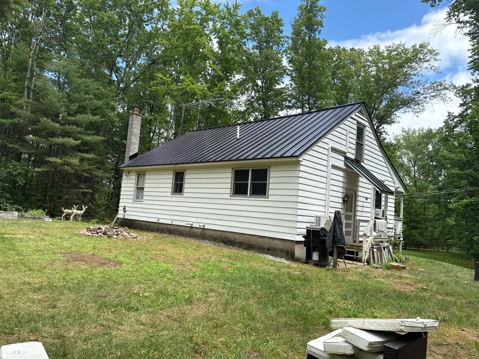 Metal Roofing Benefits: Why Many Homeowners Choose It in 2026 black standing seam metal roof home 2026 Modern black standing seam metal roof installed on a residential home