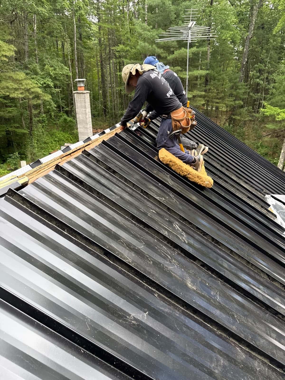 Metal Roofing Benefits: Why Many Homeowners Choose It in 2026 metal roof installation contractor working Professional roofing contractors installing standing seam metal roofing panels