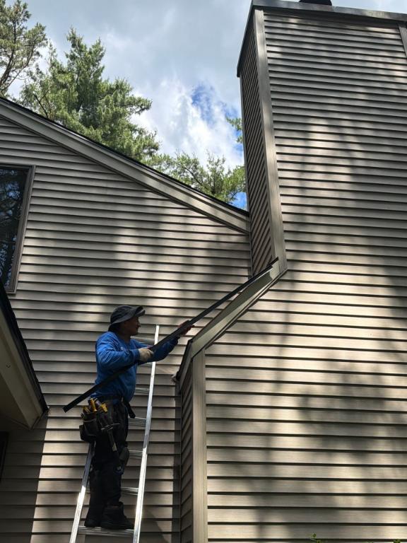 Siding contractor working on a home in Nassau NY