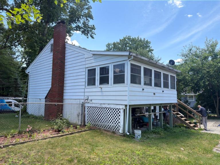 Siding contractor working on a home in North Chatham NY