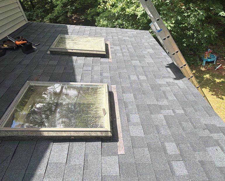 New asphalt shingle roof with replaced skylight flashing to improve waterproofing and prevent roof leaks.