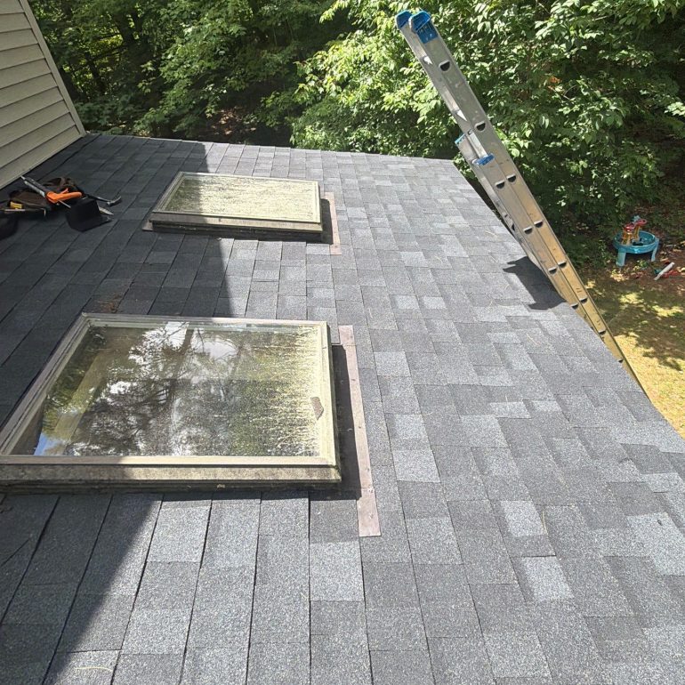 New asphalt shingle roof with replaced skylight flashing to improve waterproofing and prevent roof leaks.