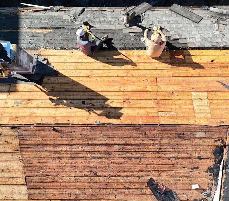 Plank roof decking exposed during roof replacement before new shingles are installed