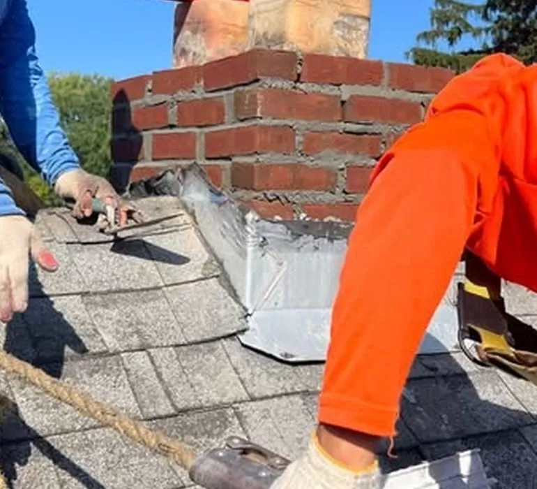 Do You Need a New Roof? A Complete Homeowner’s Guide to Roof Replacement signs you need a roof replacement Roof replacement work near chimney showing damaged shingles and flashing
