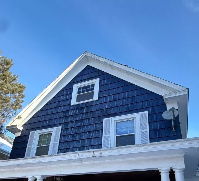 Roof Cleaning and Maintenance Tips Every Homeowner Should Know roof cleaning maintenance winter home Residential home roof in winter showing snow buildup and shingle roofing system for seasonal maintenance