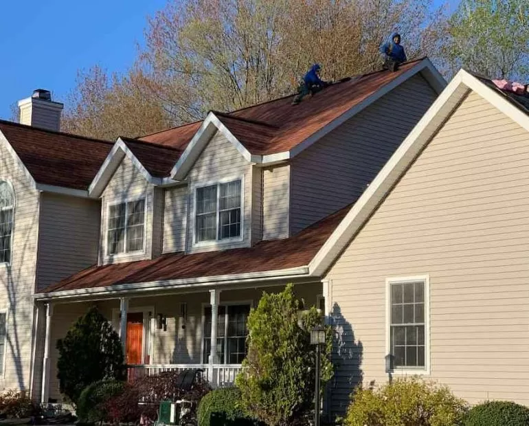 Financing Your Roof Replacement Options and Tips roof replacement financing Residential roof replacement project showing professional roofers installing new asphalt shingles on house roof