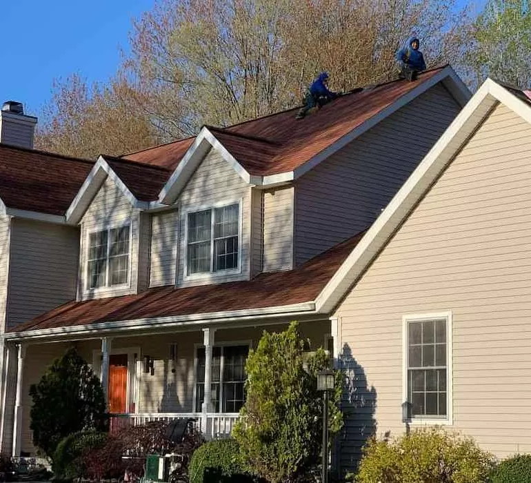 Financing Your Roof Replacement Options and Tips roof replacement financing Residential roof replacement project showing professional roofers installing new asphalt shingles on house roof