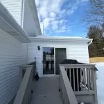 Emergency roof inspection showing snow buildup near roof edge and gutter after winter storm