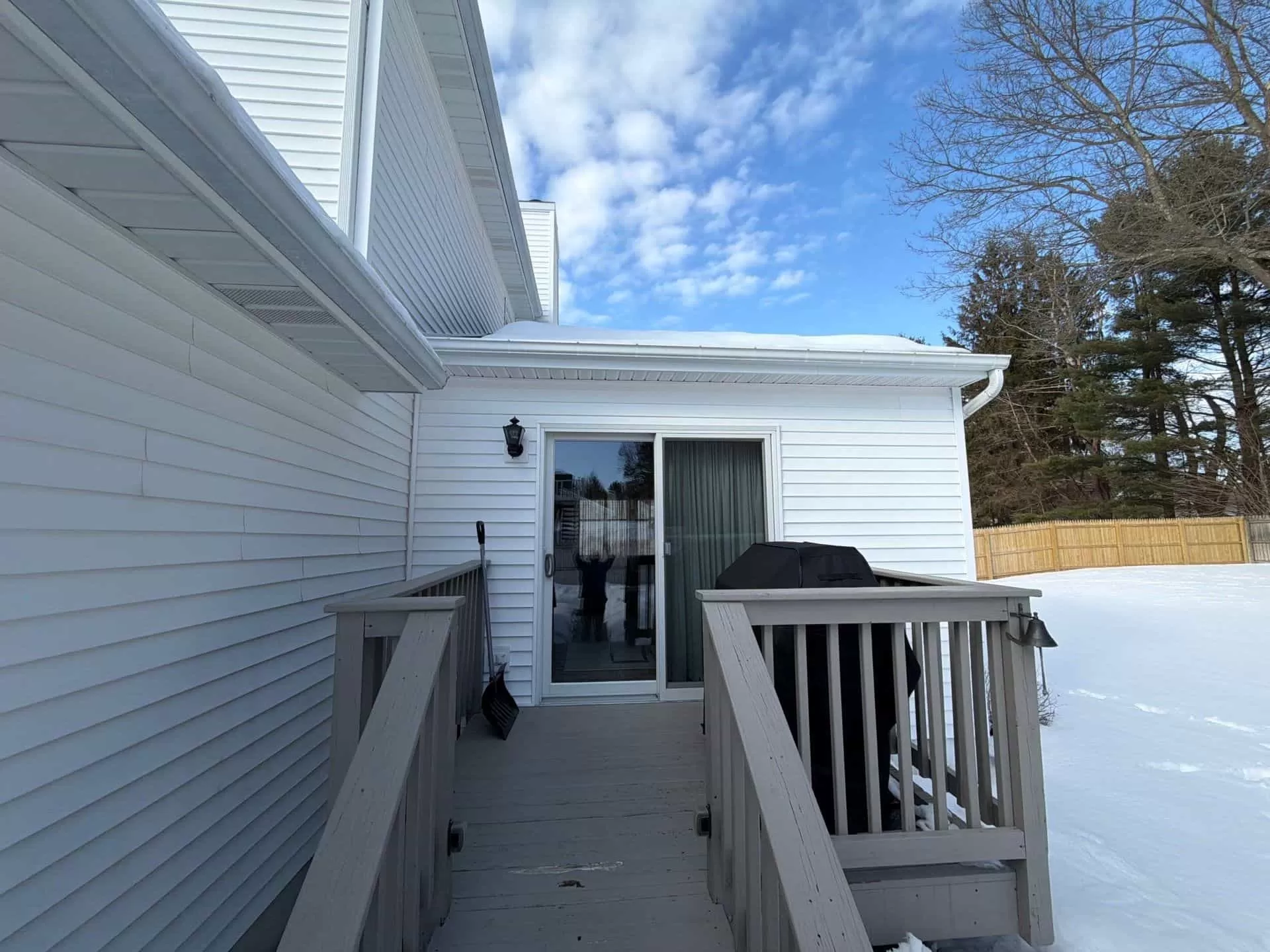 Emergency Roof Repair: What to Do After a Storm Strikes emergency roof repair snow roof edge Emergency roof inspection showing snow buildup near roof edge and gutter after winter storm