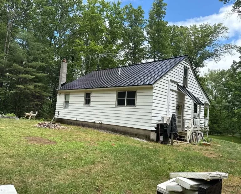 Modern black standing seam metal roof installed on a residential home