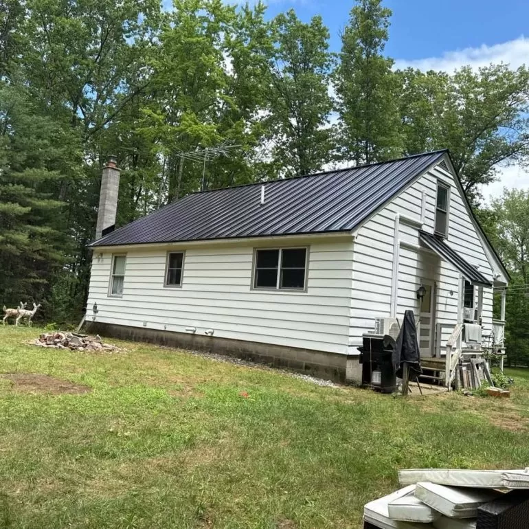 Metal Roofing Benefits: Why Many Homeowners Choose It in 2026 black standing seam metal roof home 2026 Modern black standing seam metal roof installed on a residential home