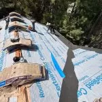 Damaged asphalt shingle roof being removed during a residential roof replacement project