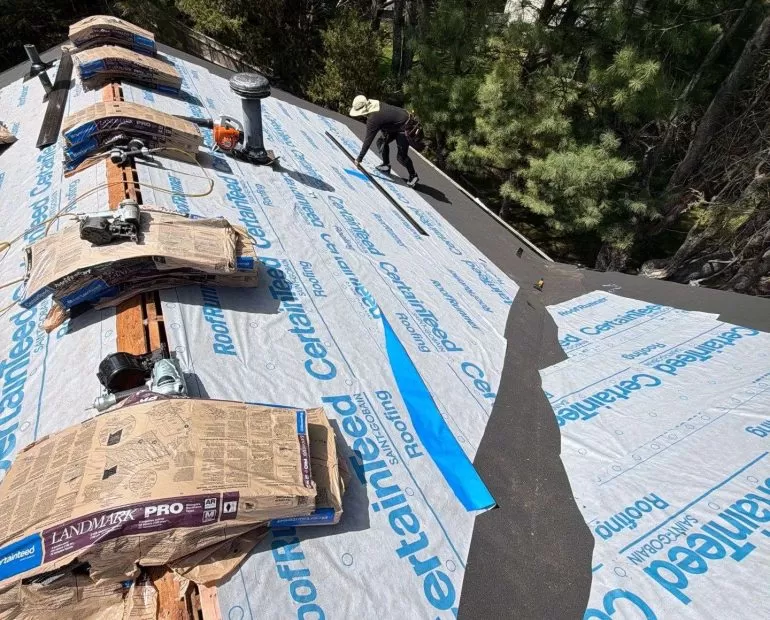 Damaged asphalt shingle roof being removed during a residential roof replacement project