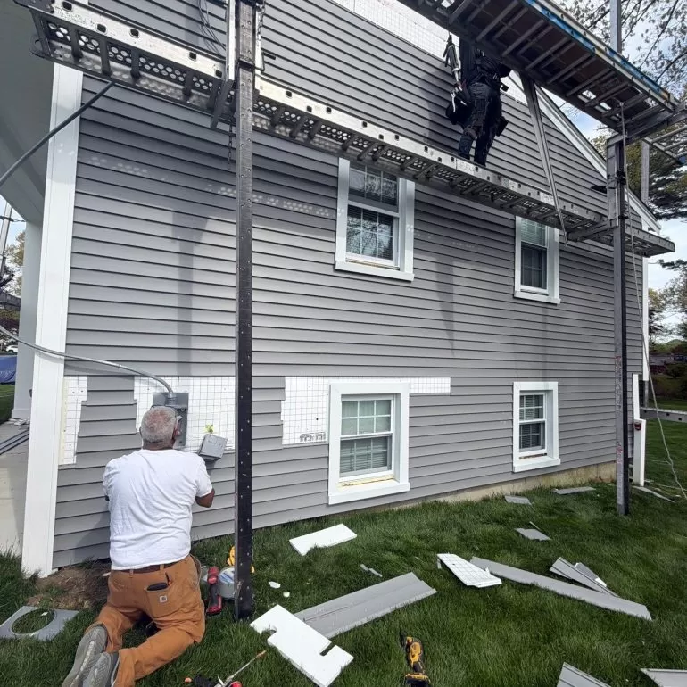 What to Expect During a Roof Replacement Project what to expect during a roof replacement project Professional contractors working on a residential home during a roof replacement and exterior renovation project