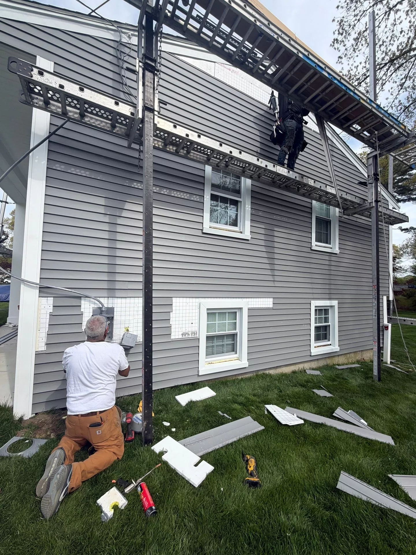 What to Expect During a Roof Replacement Project what to expect during a roof replacement project Professional contractors working on a residential home during a roof replacement and exterior renovation project