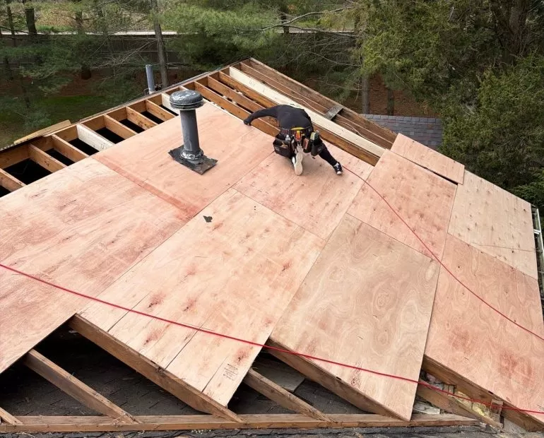 Roof Decking Replacement: Why New Plywood Sheathing Matters Before a Roof Installation roof decking replacement plywood sheathing Contractor performing roof decking replacement with new plywood sheathing during a residential roof installation project.