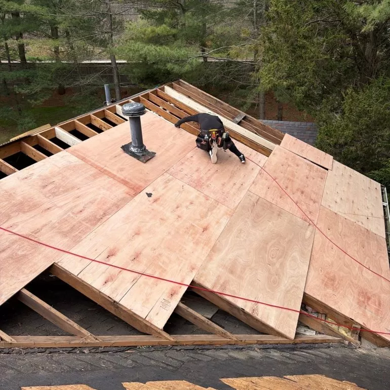 Roof Decking Replacement: Why New Plywood Sheathing Matters Before a Roof Installation roof decking replacement plywood sheathing Contractor performing roof decking replacement with new plywood sheathing during a residential roof installation project.