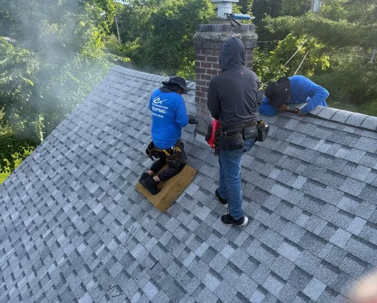 Chimney Flashing Repair for Asphalt Shingle Roofs chimney flashing repair asphalt shingle roof Roofing crew performing chimney flashing repair on an asphalt shingle roof during a residential roof replacement by Center Construction Roofing.