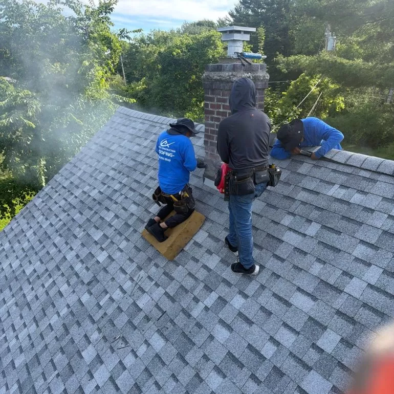 Chimney Flashing Repair for Asphalt Shingle Roofs chimney flashing repair asphalt shingle roof Roofing crew performing chimney flashing repair on an asphalt shingle roof during a residential roof replacement by Center Construction Roofing.