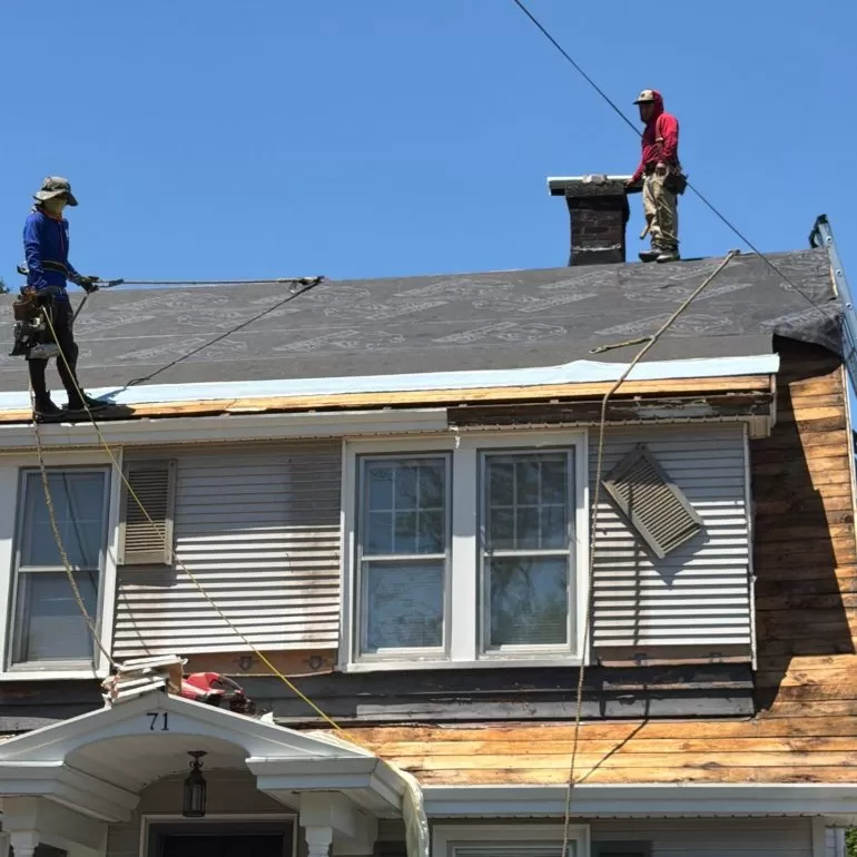 Why Roof Edge Protection Matters During Roof Replacement roof edge protection during roof replacement Roofing crew installing roof edge protection and synthetic underlayment during a residential roof replacement by Center Construction Roofing.