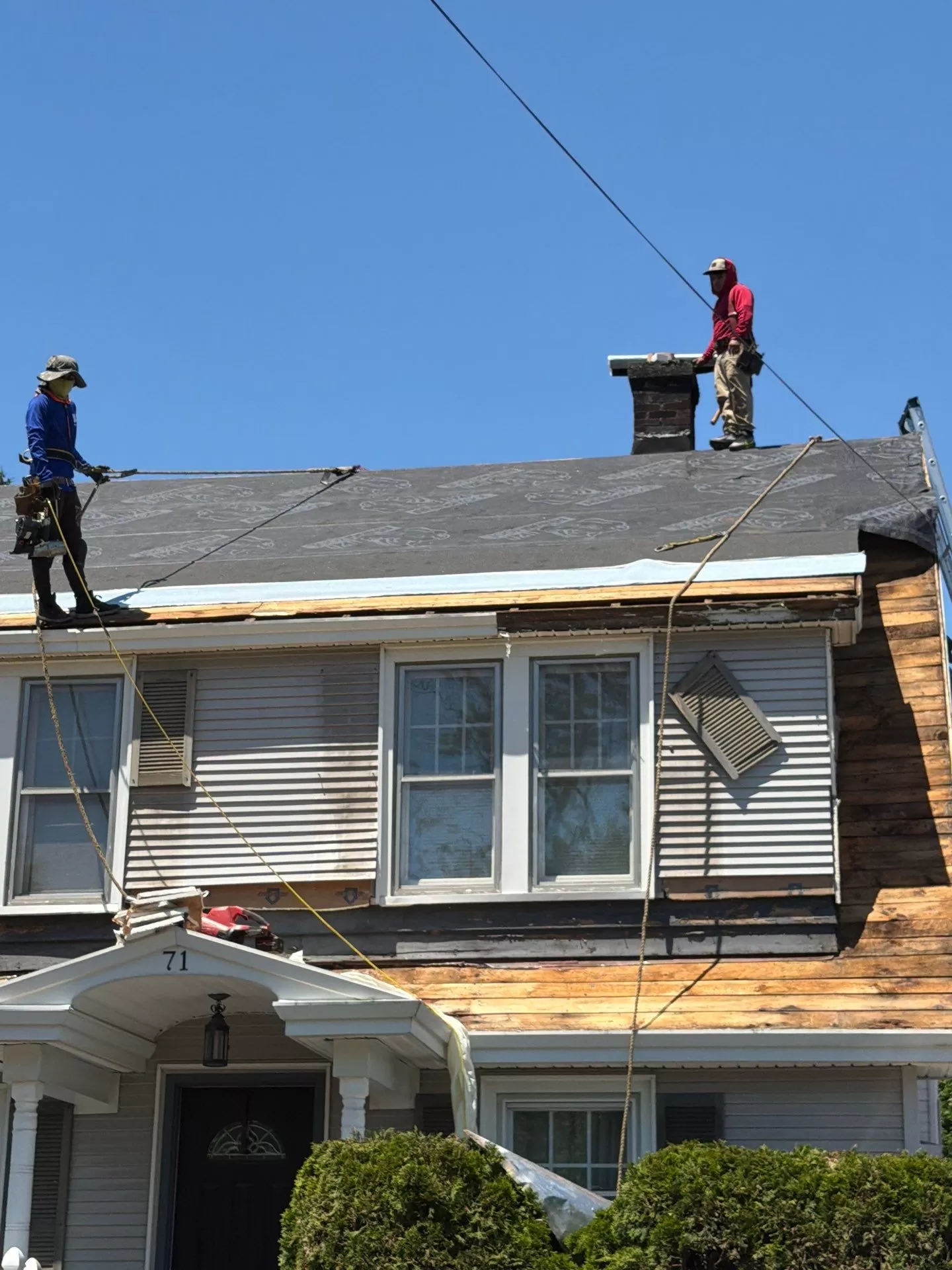 Why Roof Edge Protection Matters During Roof Replacement roof edge protection during roof replacement Roofing crew installing roof edge protection and synthetic underlayment during a residential roof replacement by Center Construction Roofing.