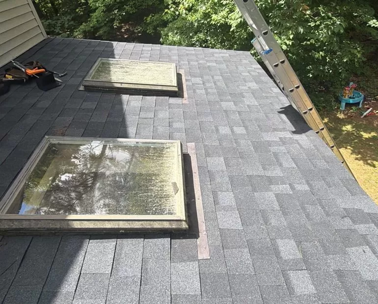 Skylight Roof Flashing Replacement: Protecting Your Roof from Leaks skylight roof flashing replacement New asphalt shingle roof with replaced skylight flashing to improve waterproofing and prevent roof leaks.