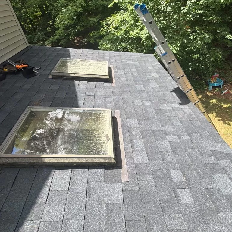 Skylight Roof Flashing Replacement: Protecting Your Roof from Leaks skylight roof flashing replacement New asphalt shingle roof with replaced skylight flashing to improve waterproofing and prevent roof leaks.