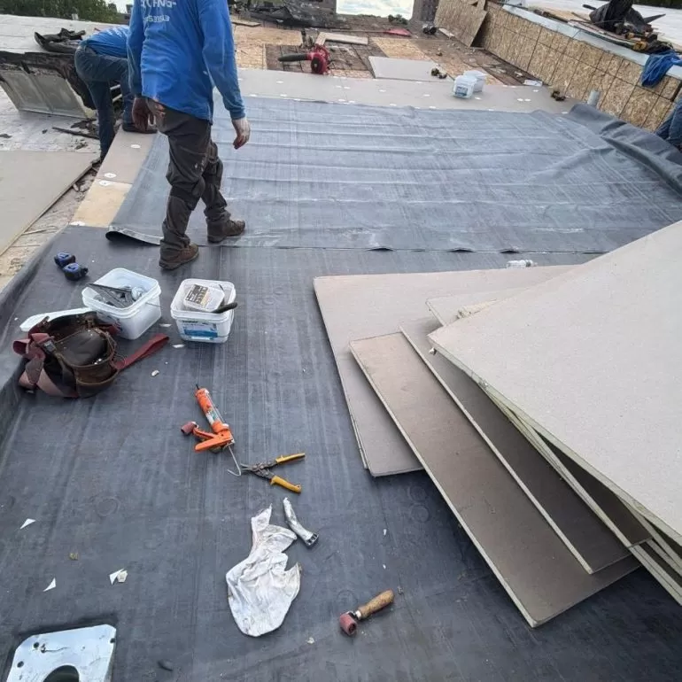 Commercial Flat Roof Membrane Preparation: Key Installation Steps commercial flat roof membrane preparation Commercial flat roof membrane preparation with workers installing roofing material over an exposed roof surface